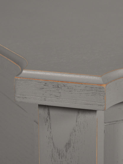 Close-up of a wooden surface with a gray background