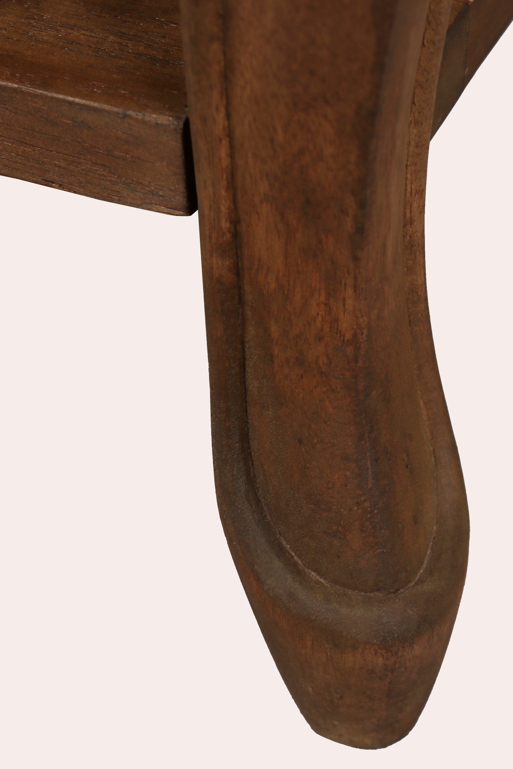 Close-up of a wooden chair leg on a white background