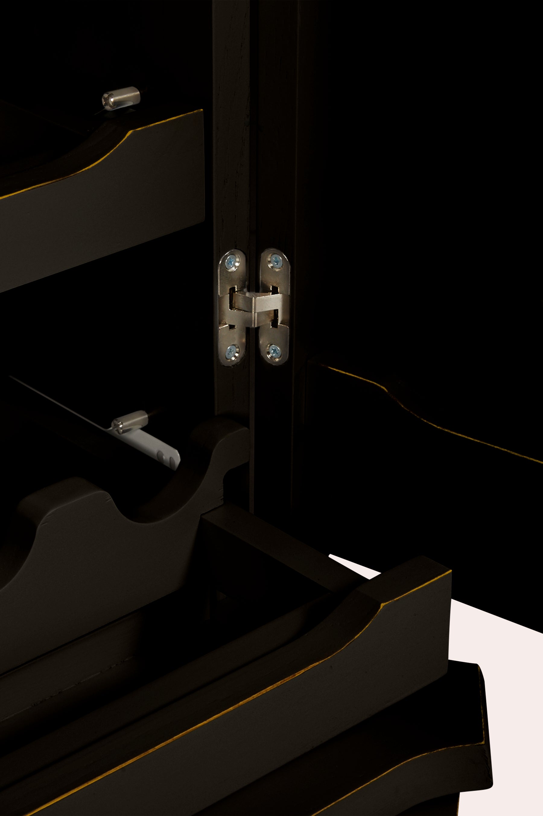 Close-up of a black drinks cabinet with visible hinges.