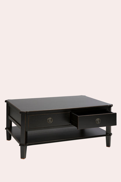 Black coffee table with a drawer on a beige background