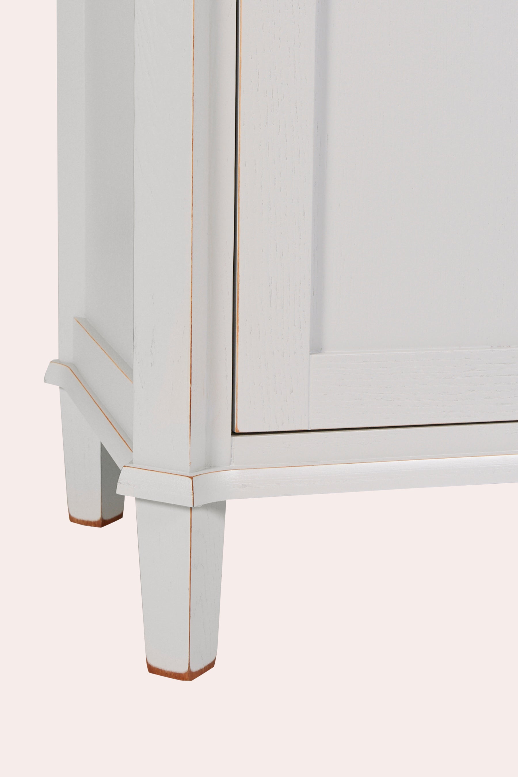 White cabinet with gold trim on a white background