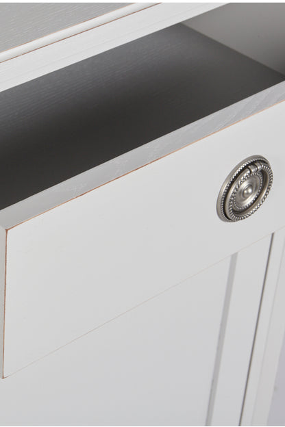 Close-up of a white cabinet with a decorative knob on a gray surface