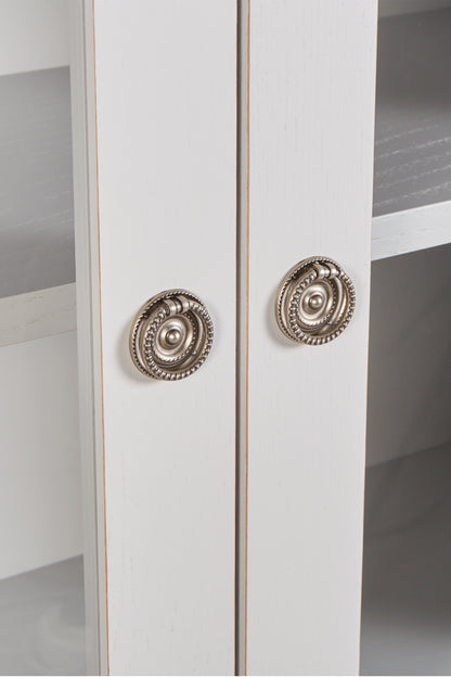 White cabinet with decorative silver handles on a white background