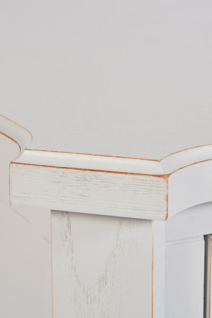 Close-up of a white wooden cabinet with a gold trim on a light gray background