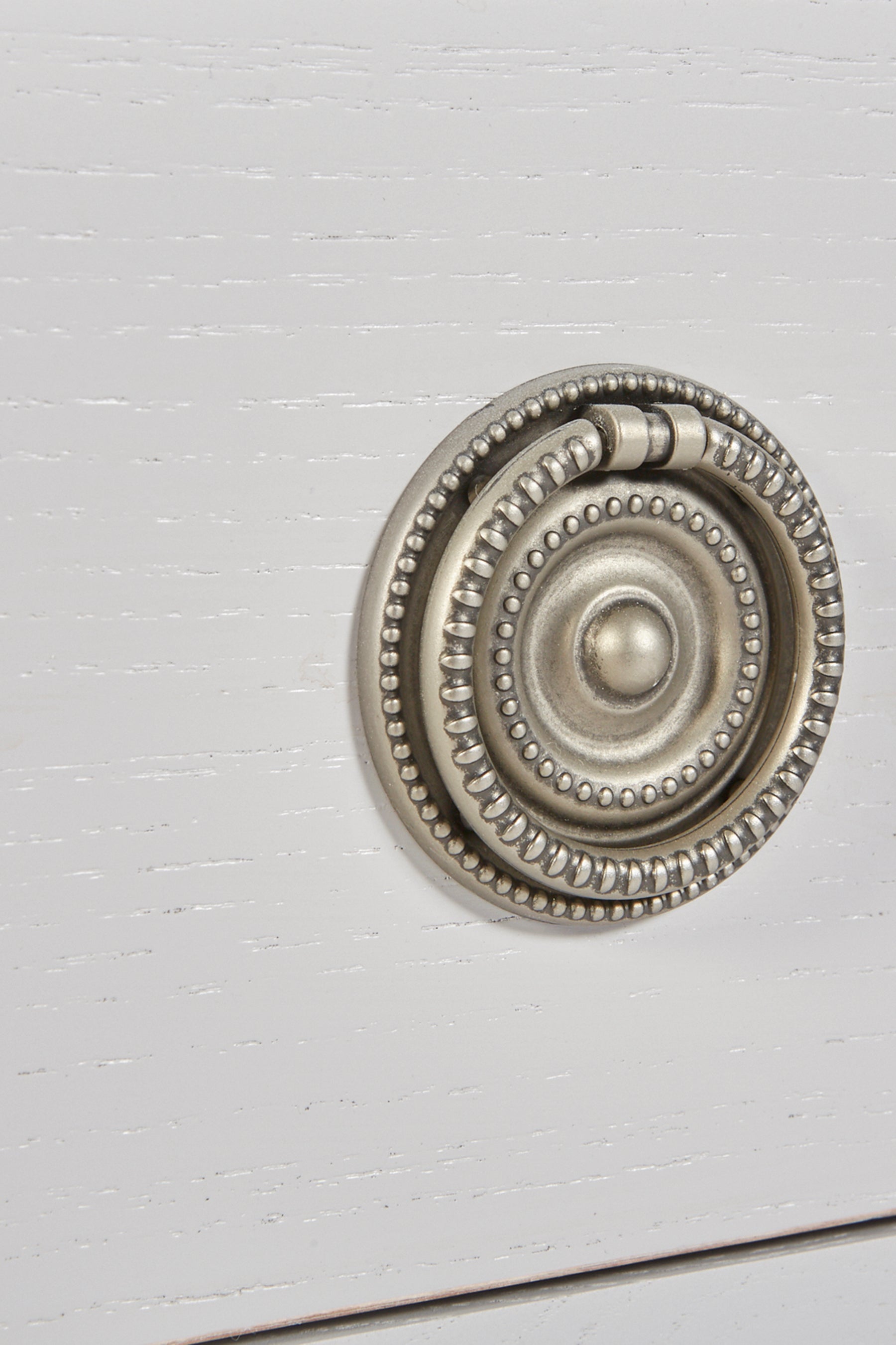 Decorative metal knob on a white door