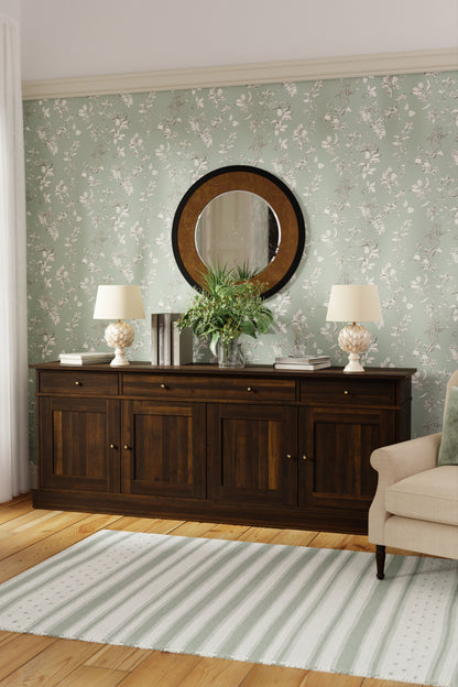 Room with floral wallpaper, wooden furniture, and decorative items.