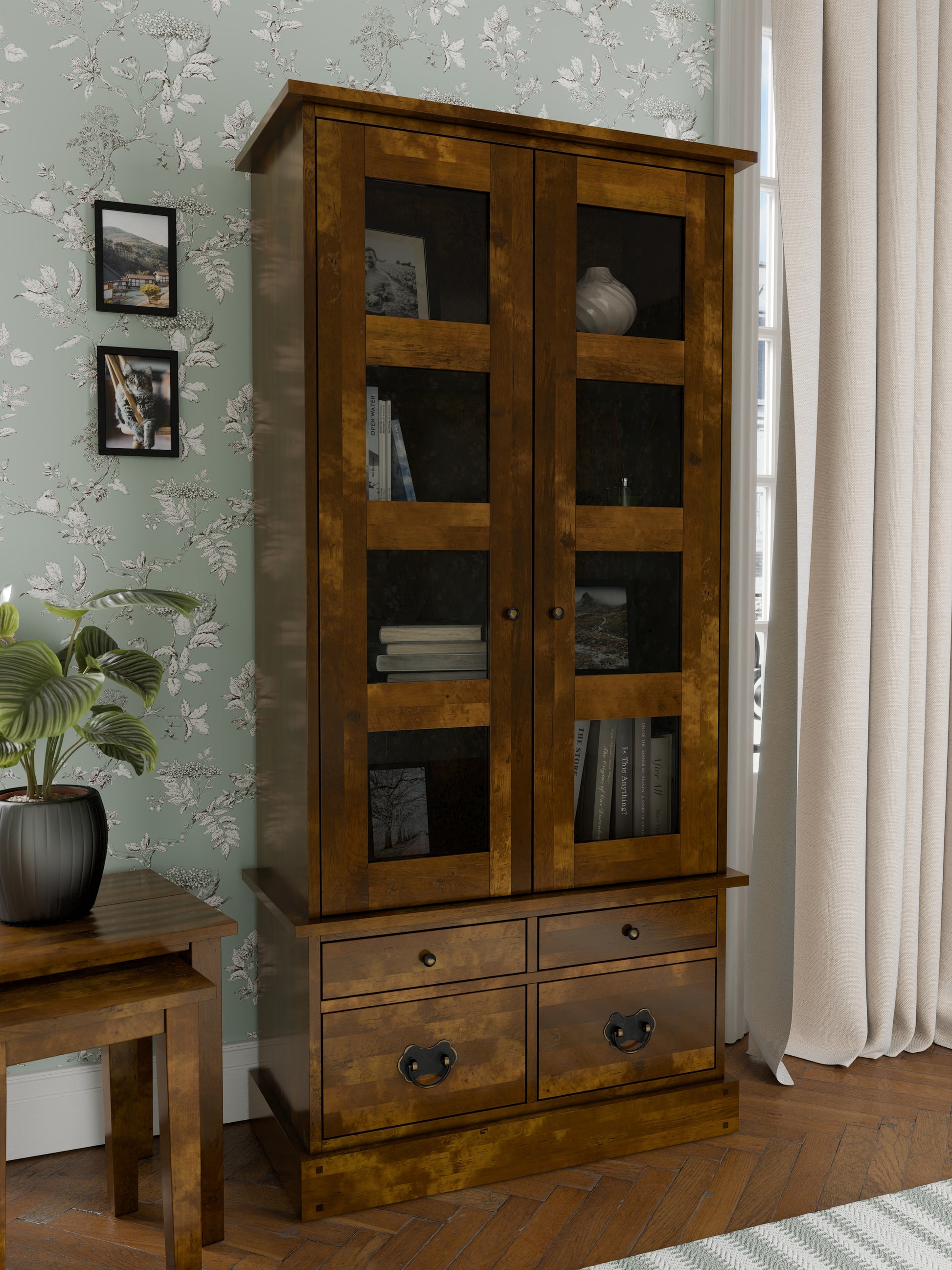 Wooden cabinet with glass doors and drawers in a room setting.