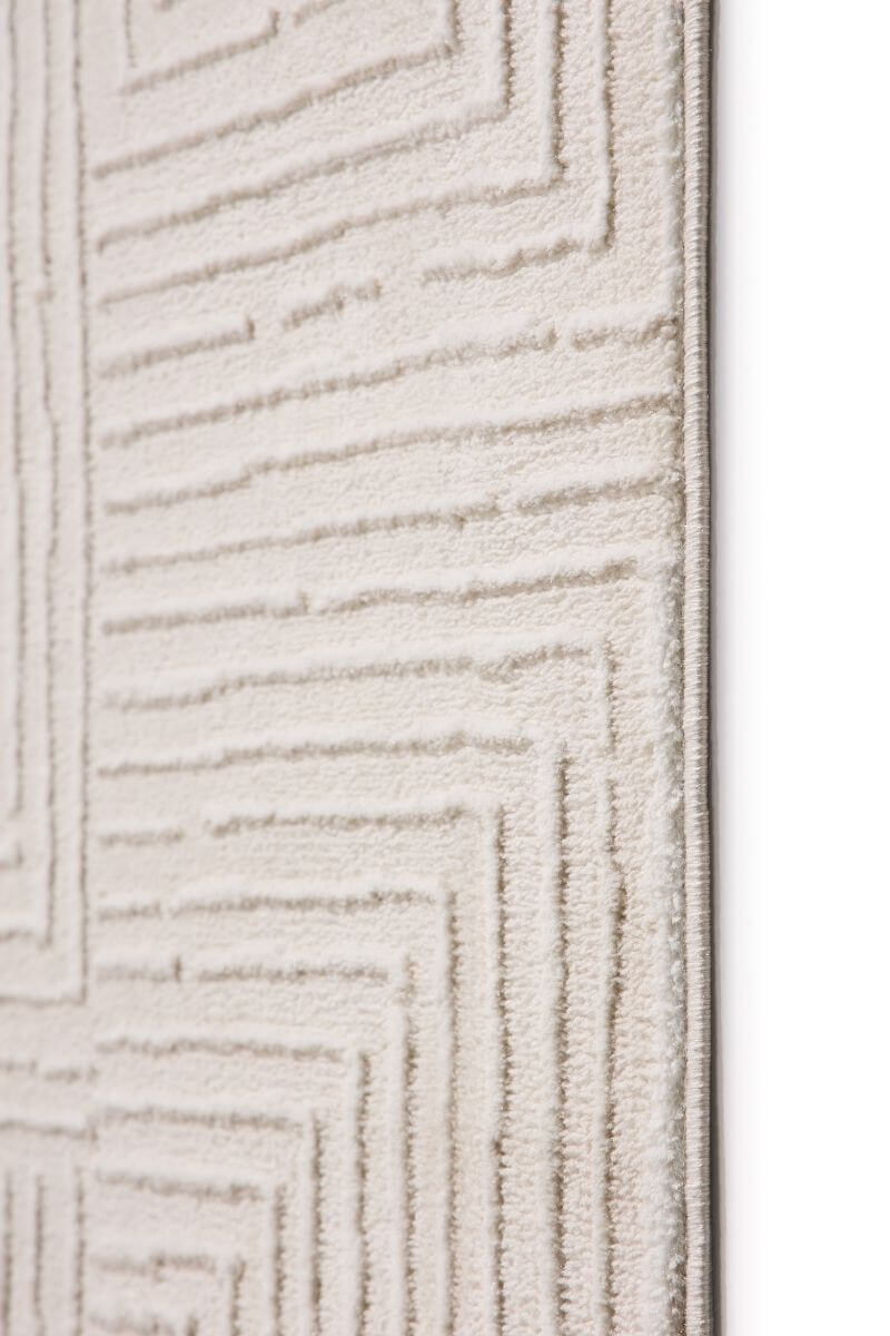 Textured beige carpet with geometric pattern on a white background