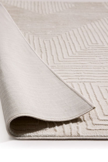 Close-up of a textured beige rug with geometric pattern on a white background