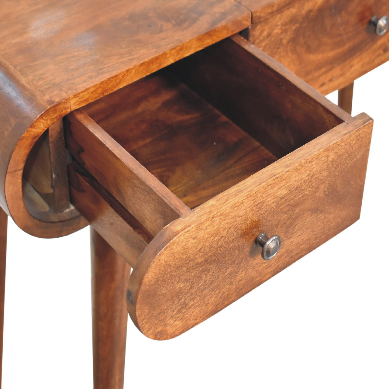 Detailed close-up of an open left hand drawer on a wooden dressing table with a round metal knob and visible wood grain.