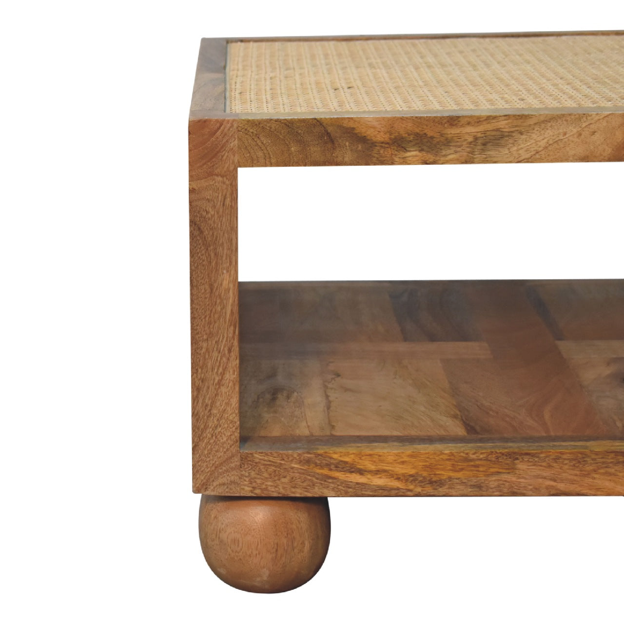 Close-up of the corner of a square wooden coffee table, showing the smooth join between the polished wood frame and rattan panel.