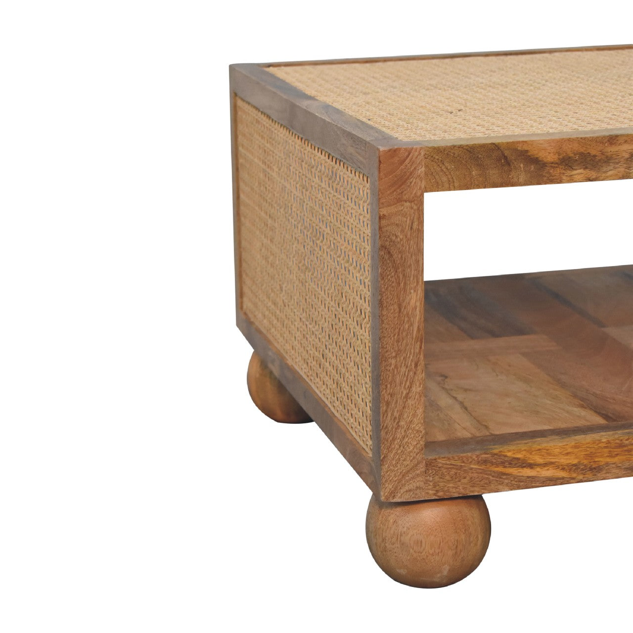 Angled corner and side profile of a wooden coffee table with a box-like square frame, rattan panelling, and spherical wooden feet.