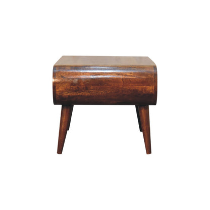 Side profile of a curved wooden coffee table with a smooth continuous frame, integrated open shelf, and angled legs for stability.