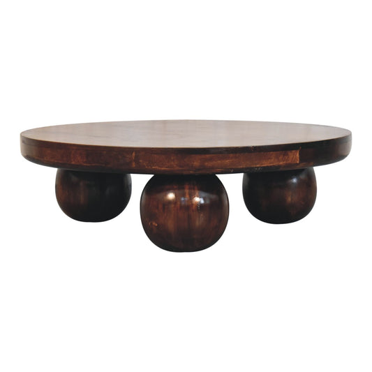 Round wooden coffee table with 3 spherical wooden legs against a white background