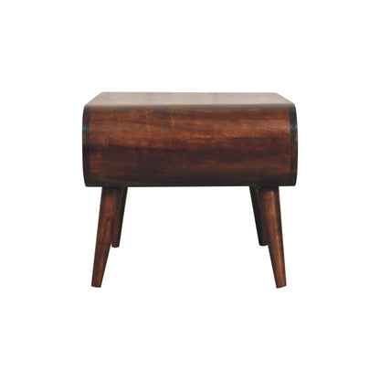 Side view of oval flat topped dark brown wooden coffee table on a white background