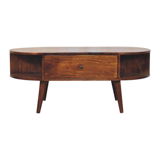 Mid-century style oval wooden coffee table with tapered legs, a central drawer, and open side shelving.