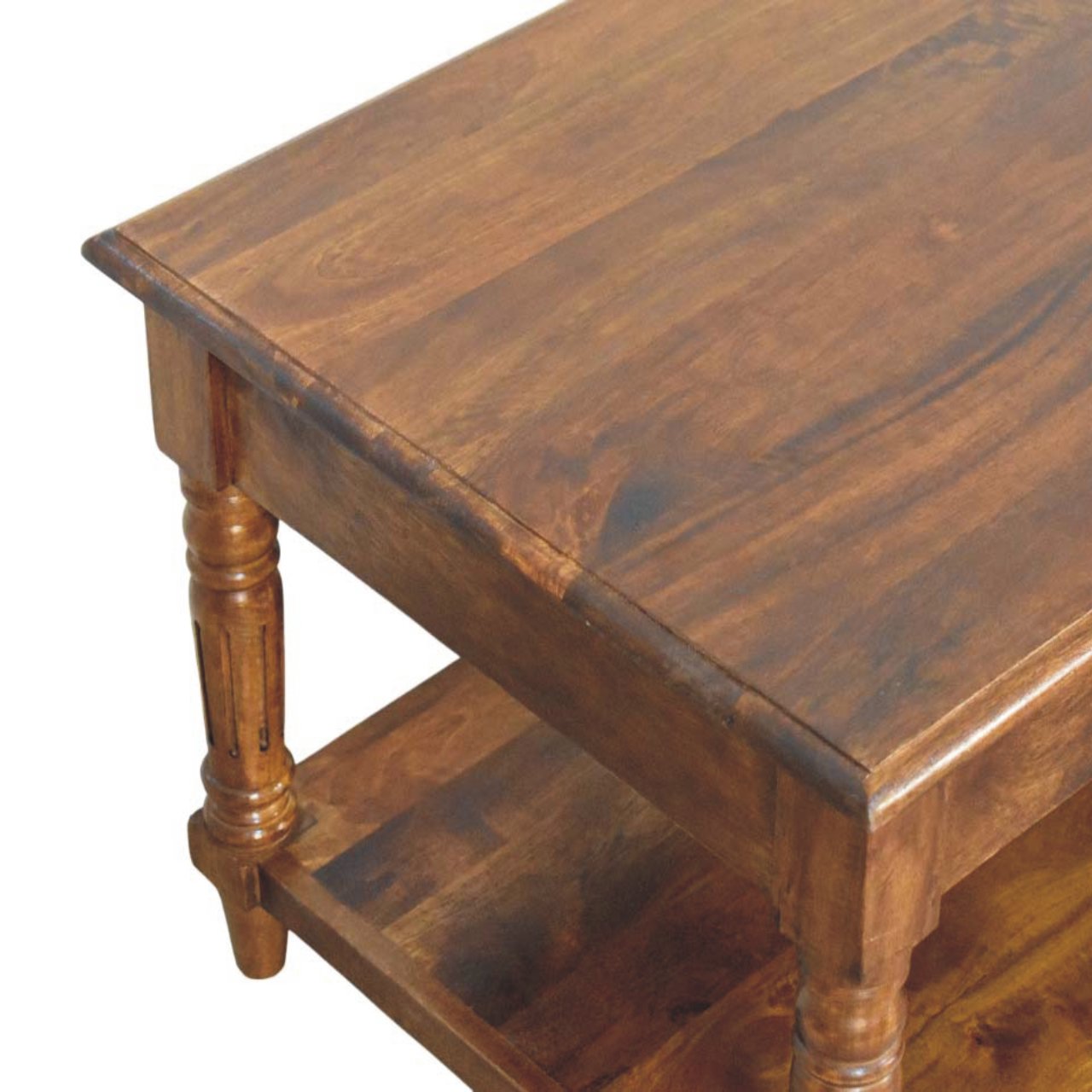 Top view of the corner of the wooden coffee table, showing its flat polished wooden surface and rectangular form.