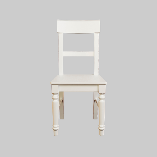 A white wooden dining chair with a full back and seat, viewed from the front.