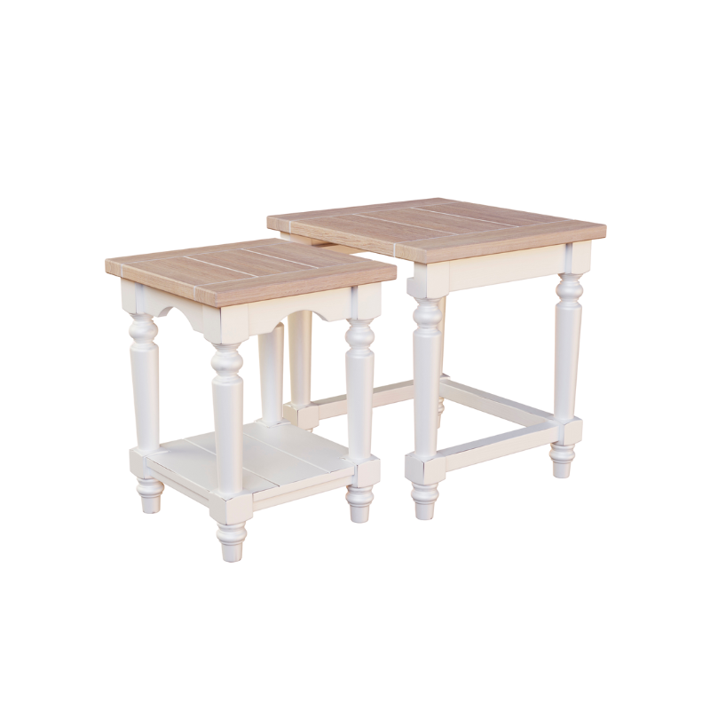 A white and brown nest of two tables with a wooden top and carved legs. he 2 tables are next to each other