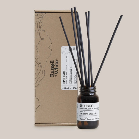 bottle with reed diffusers next to brown box for packaging