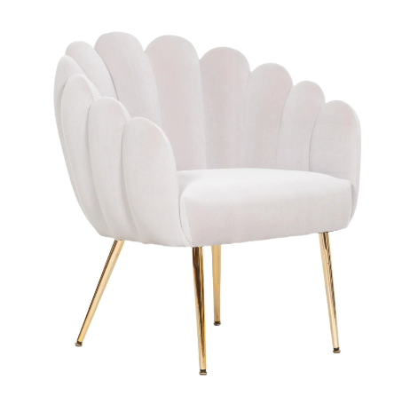 A grey velvet accent chair with scalloped edges and gold plated metal legs.