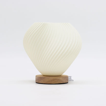 White textured table lamp with wooden base on a white background