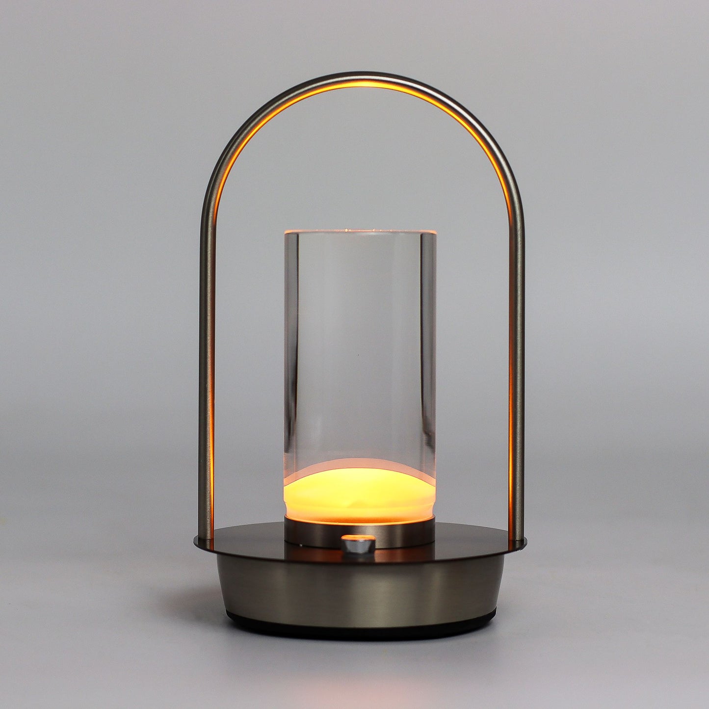 Modern lantern-style touch lamp with glass cover and glowing interior on a grey background