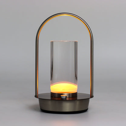 Modern lantern-style touch lamp with glass cover and glowing interior on a grey background