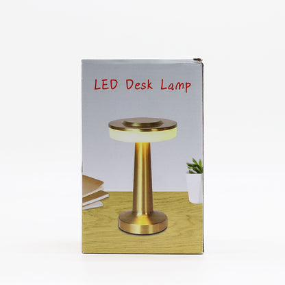 Box packaging of an LED desk touch lamp with a gold base on a white background