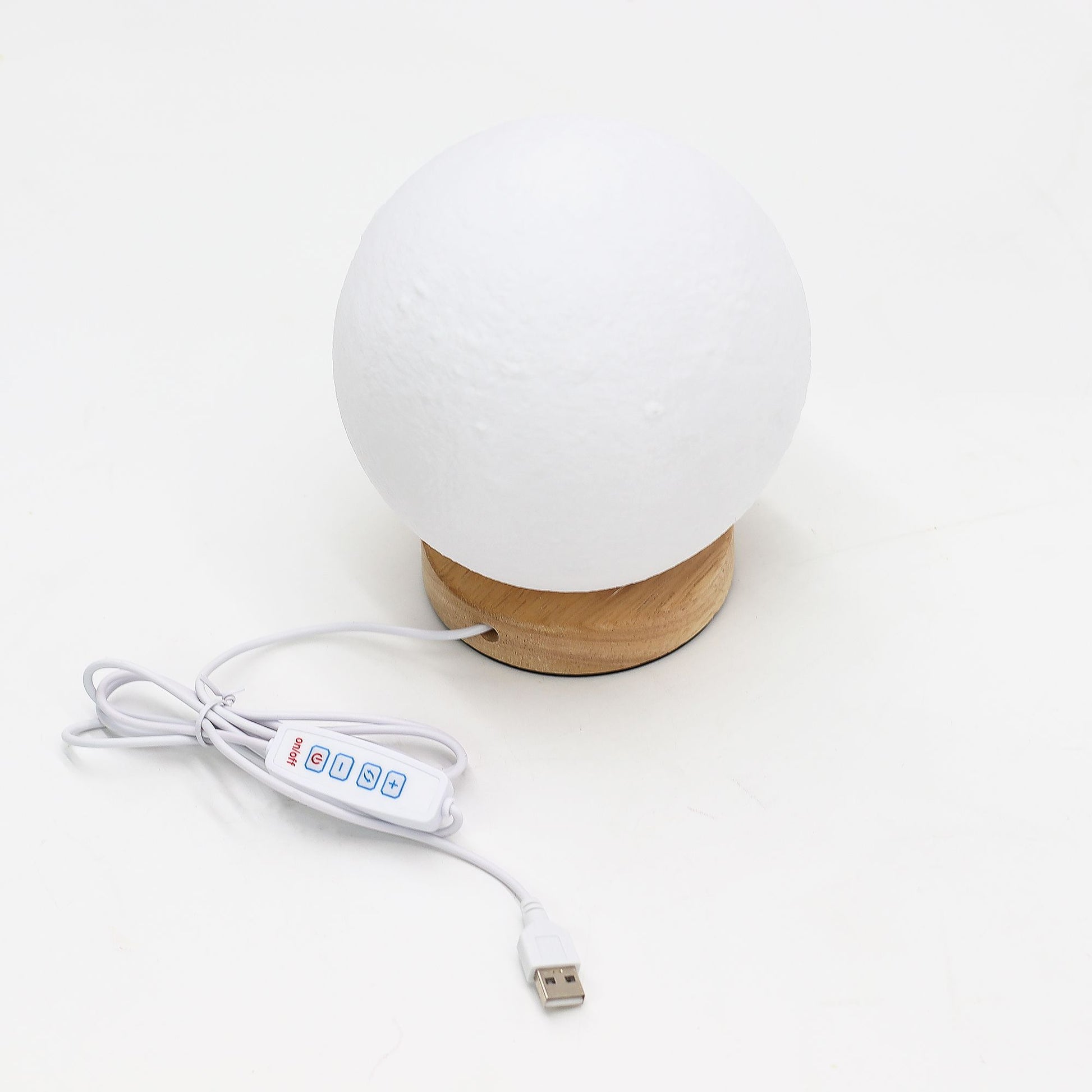 White spherical lamp with wooden base and USB cable on a white background