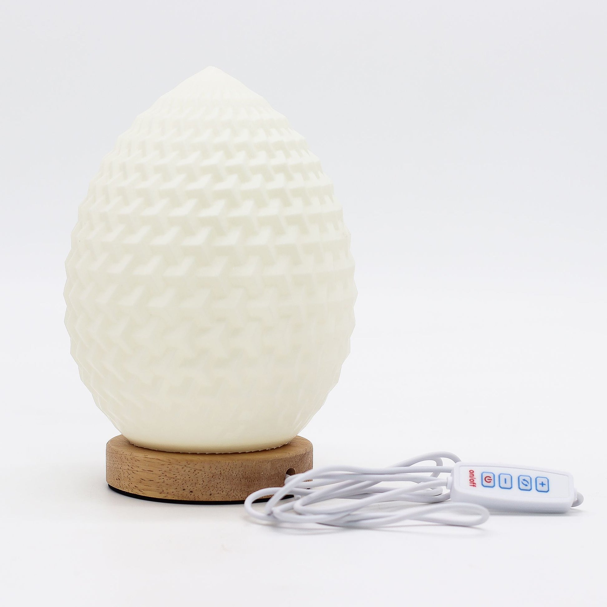White textured diffuser with wooden base and control cable on a white background