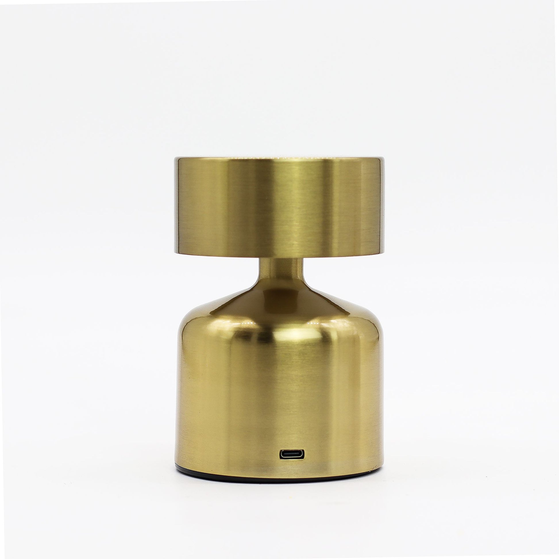 Gold metallic rechargeable table touch lamp on a white background