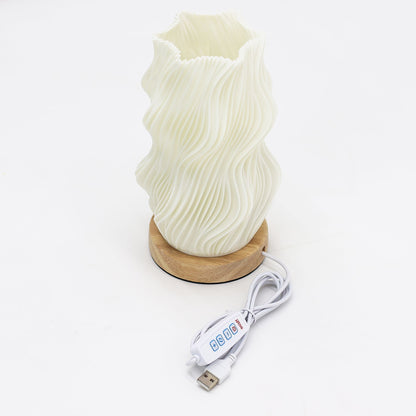 White textured lamp with wooden base and USB cable on a white background