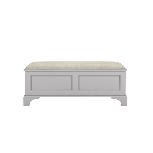 A dove grey blanket box with a cushioned top and wooden body, designed for storage and seating.