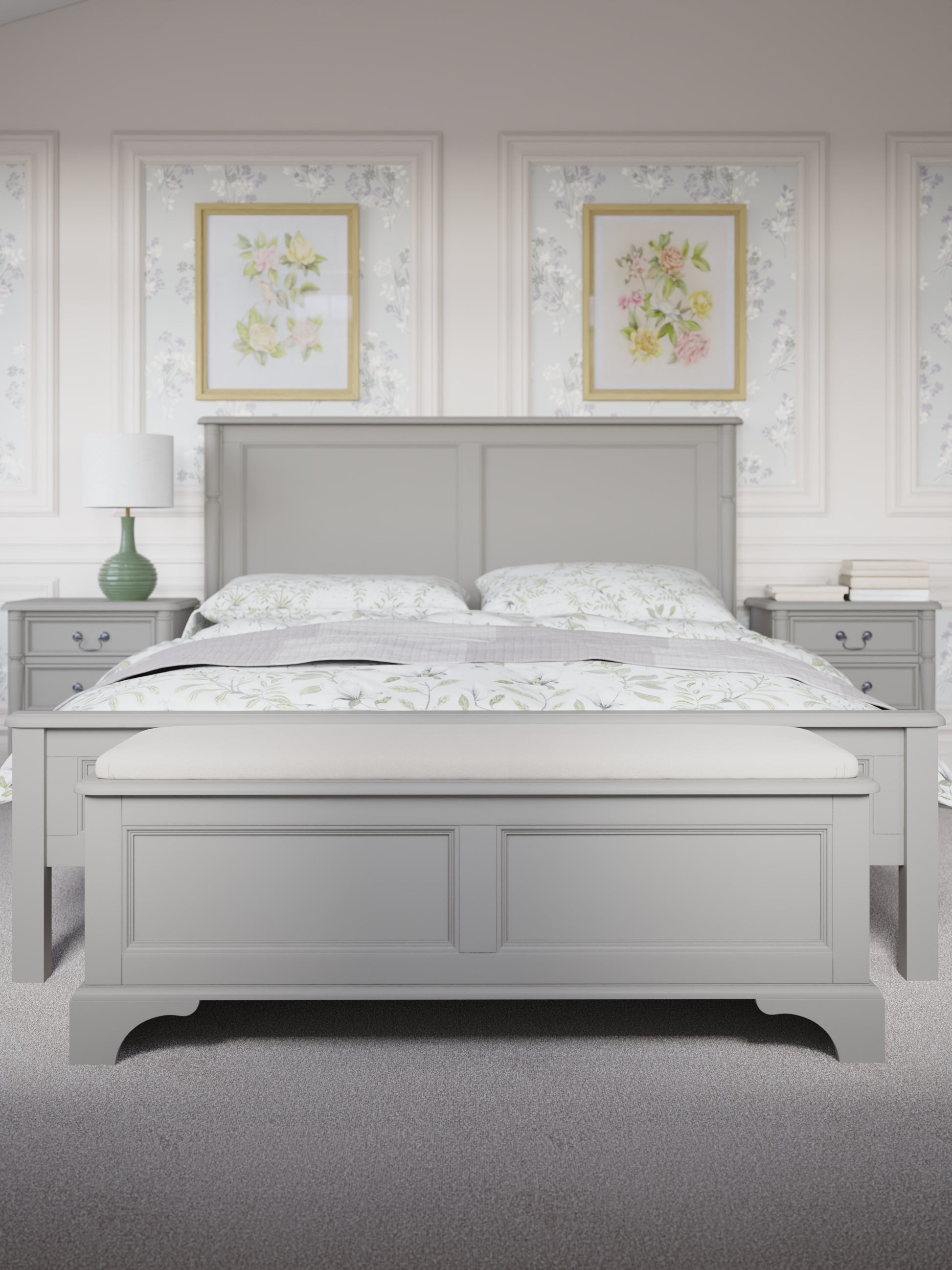 A dove grey blanket box with a cushioned top and wooden body, designed for storage and seating. The blanket box is situated at the end of a bed