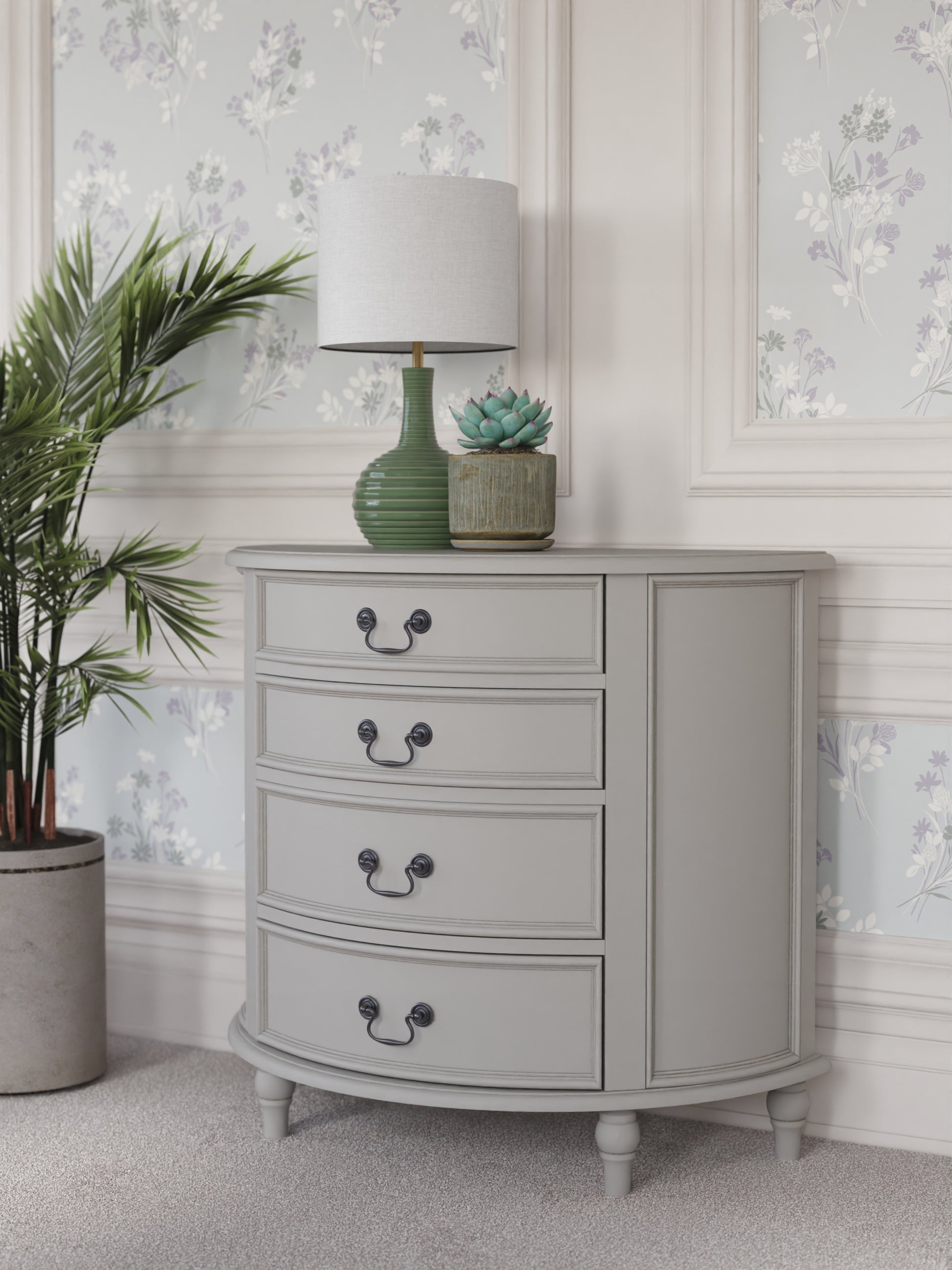 A dove grey 4-drawer half moon chest of drawers with a curved front and traditional metal handles.