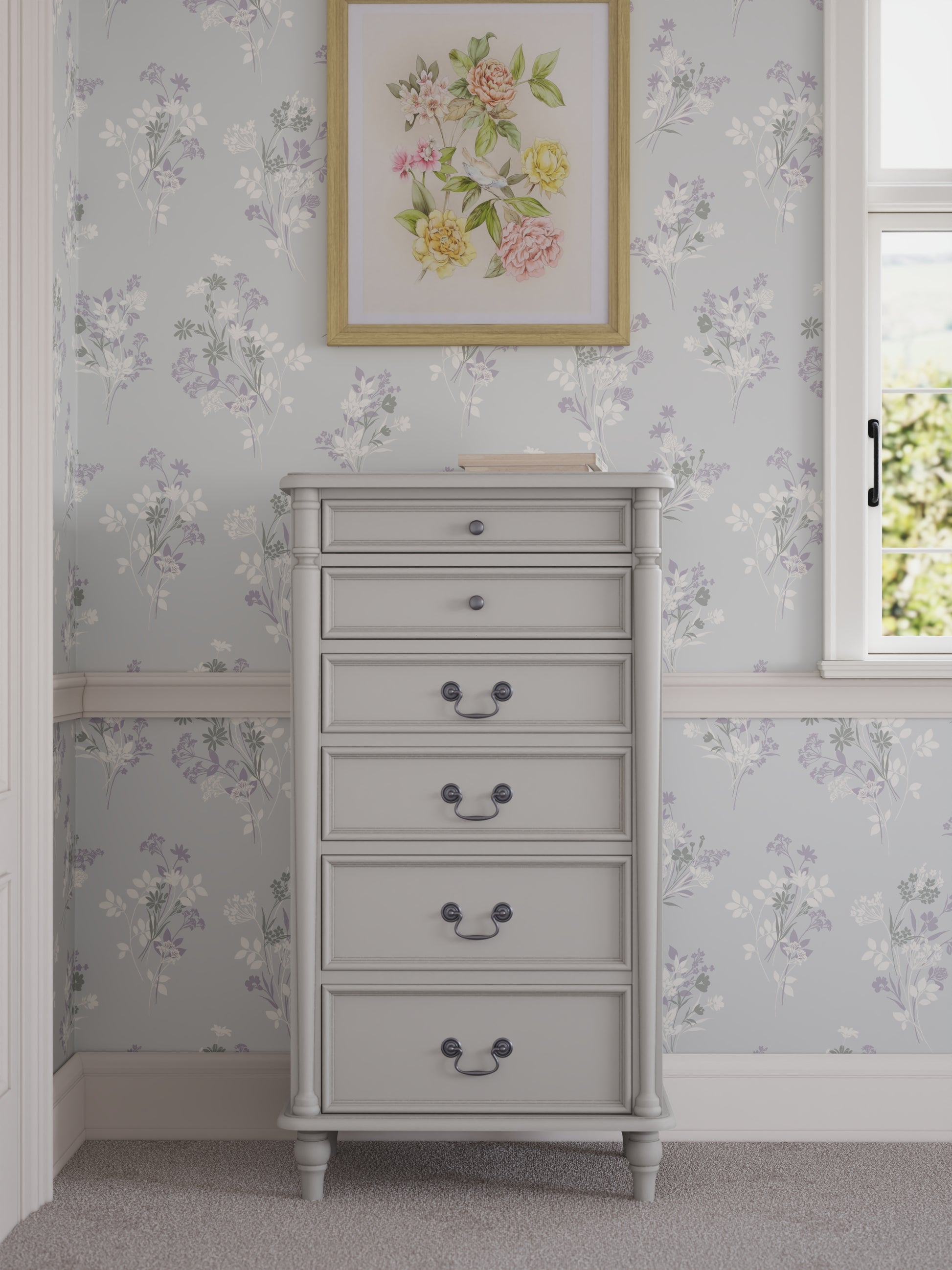 A Laura Ashley Clifton 6 Drawer Tall Chest in grey colour with a traditional design. Floral wallpaper is the background and a floral framed design hang on the wall