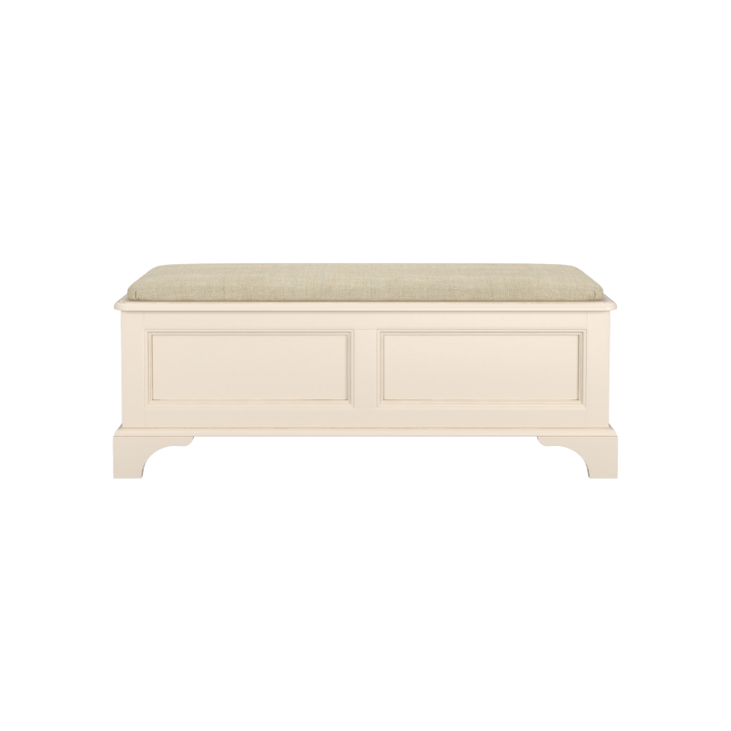 An ivory-coloured wooden blanket box with a cushioned lid, featuring a traditional design with panelled sides and a straight base.