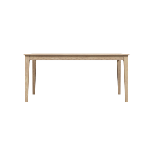 A rectangular oak dining table with a washed finish and visible wood grain, having a minimalist design with simple legs.