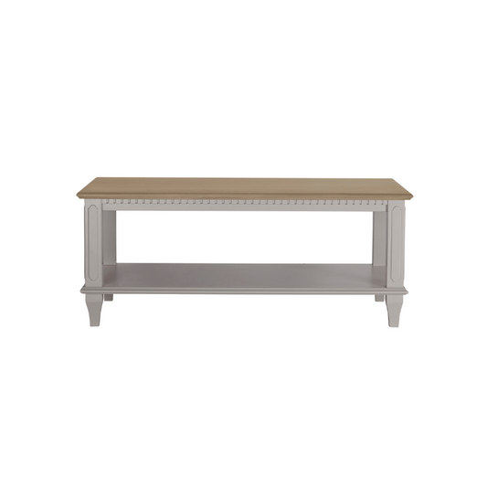 A pale French grey coffee table with a wooden top and shelf, featuring a classic design with detailed edges and legs.