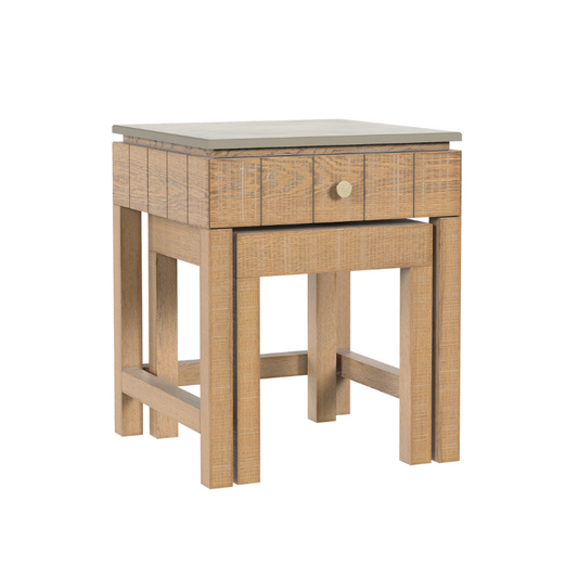 A washed oak wooden nest of tables with a single drawer, traditional style.