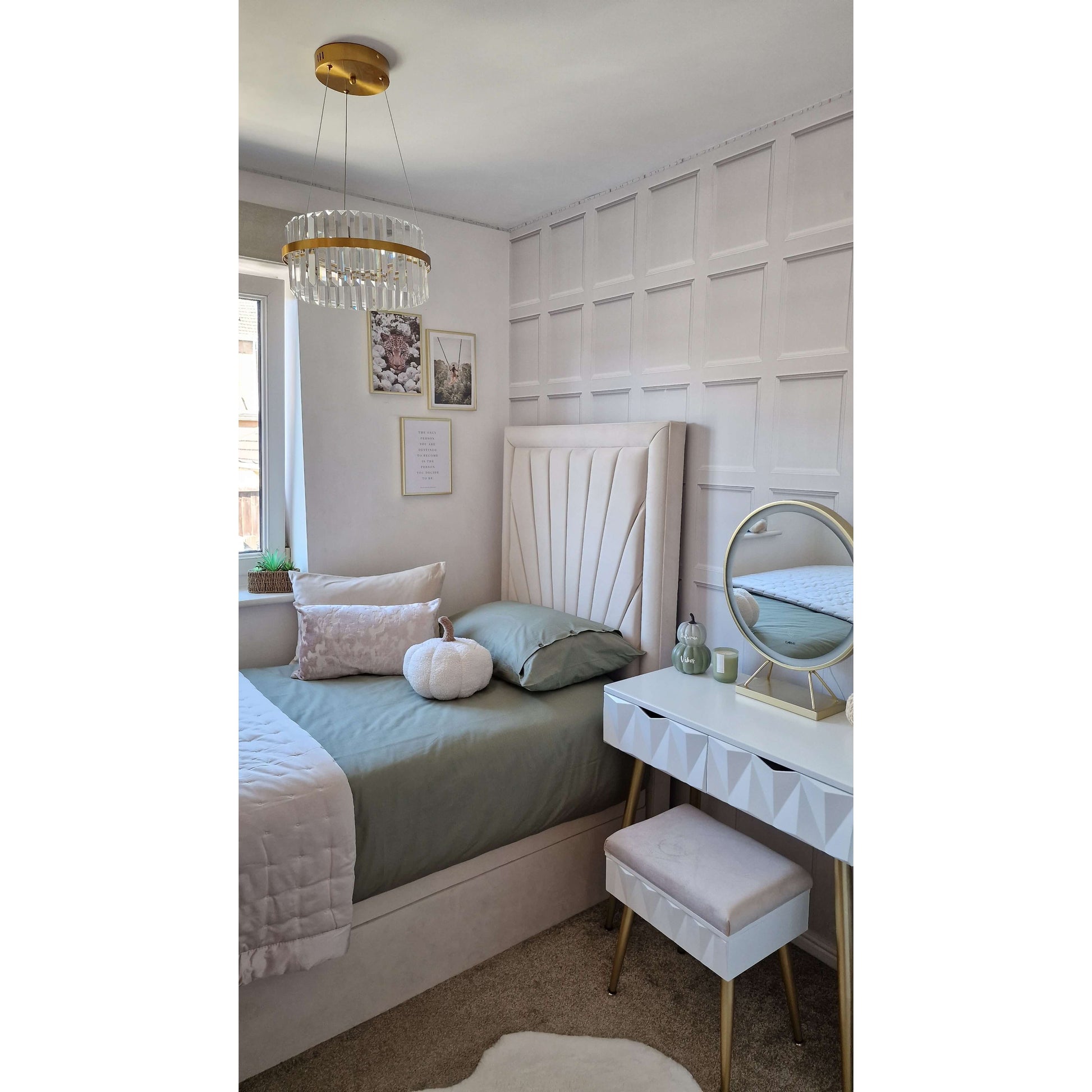 Neatly arranged bedroom with a bed, vanity table, and decorative elements.