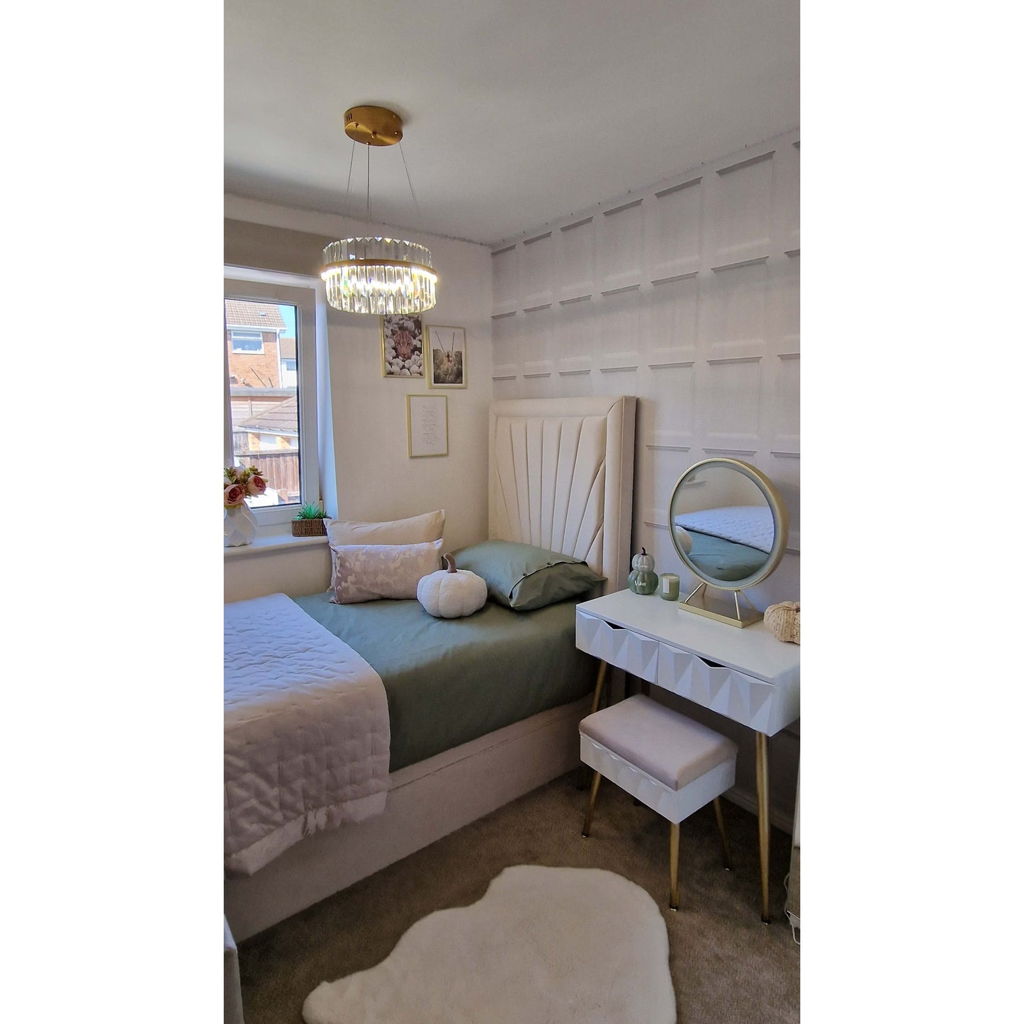 Neatly arranged bedroom with a bed, desk, and decorative items.