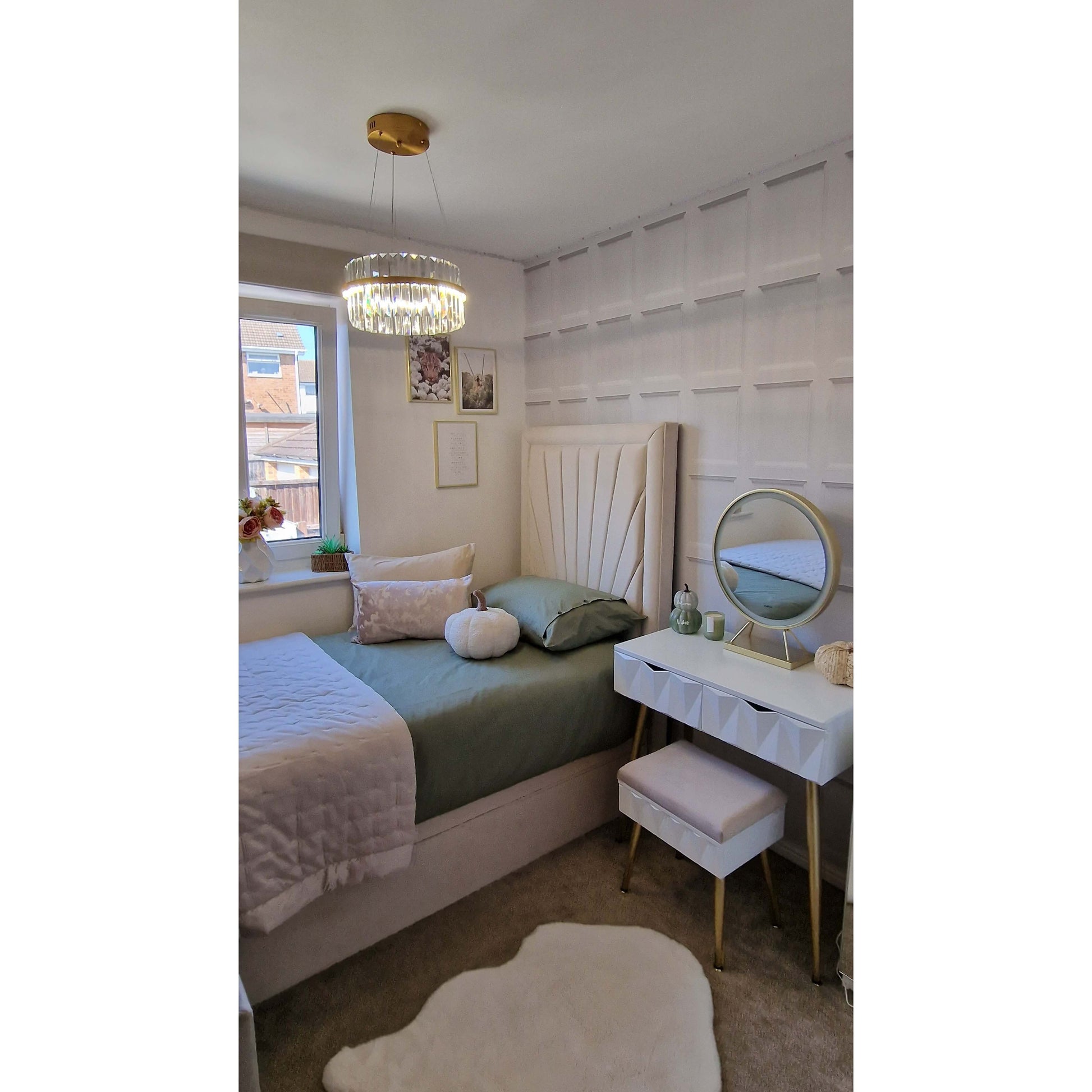Neatly arranged bedroom with a bed, desk, and decorative items.