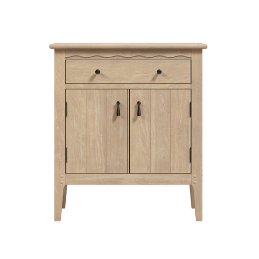 A washed oak cabinet with two doors and one drawer, featuring a traditional design with scalloped edge detailing.