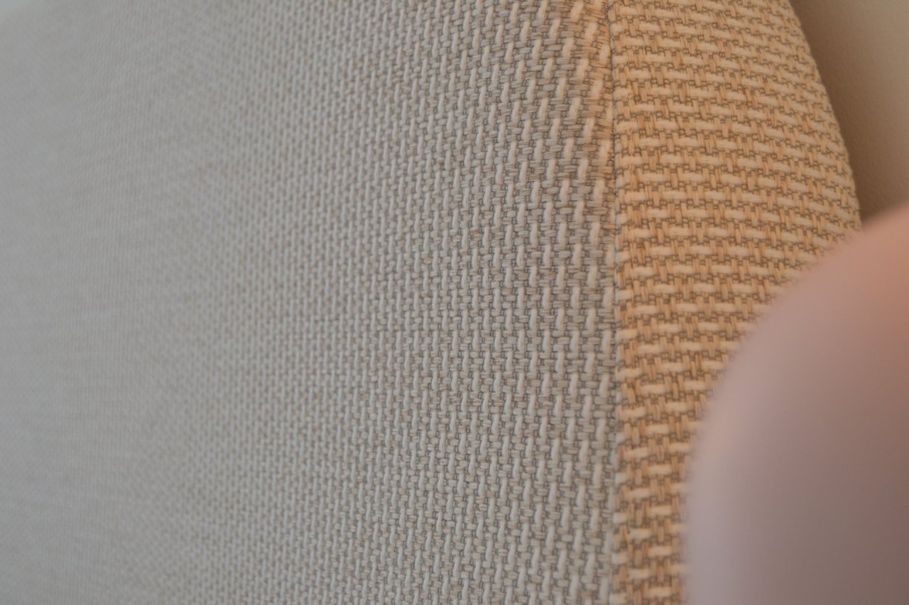 Close-up of textured fabric with a gradient from gray to brown.