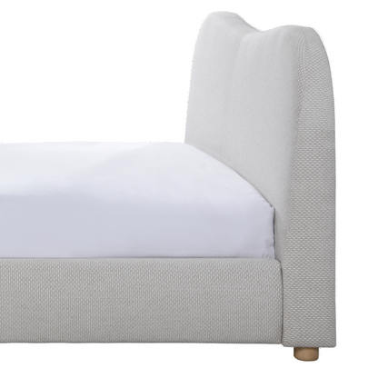 Gray upholstered bed frame with a white mattress on a white background